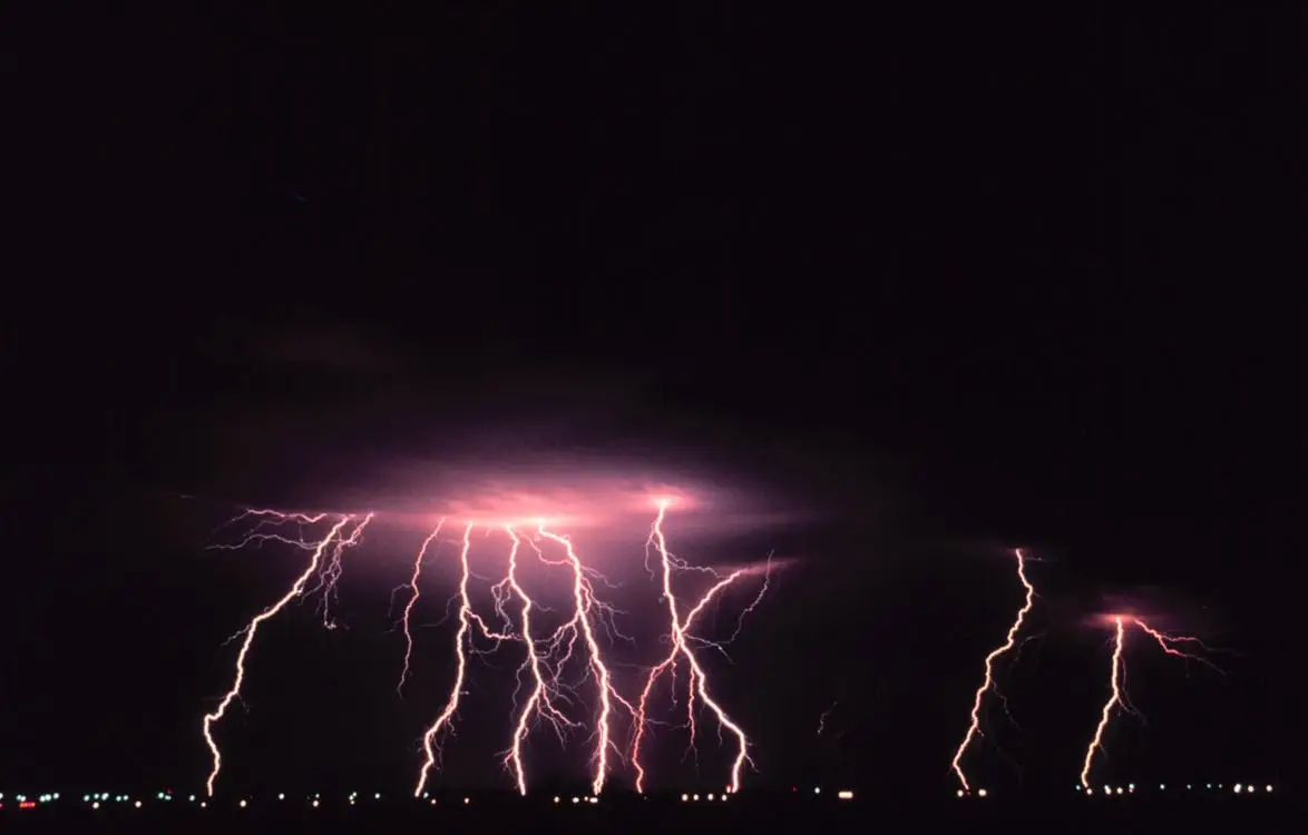 Storm on the horizon with many lightning bolts scattering downward.